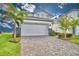 Two-story house with white garage door and paver driveway at 1687 Kona Ln, Davenport, FL 33897