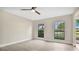 Bright bedroom with ceiling fan and view of the street at 7972 Snowberry Cir, Orlando, FL 32819
