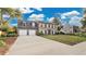 Two-story brick home with a two-car garage and landscaped yard at 7972 Snowberry Cir, Orlando, FL 32819