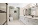Elegant bathroom with double vanity, soaking tub, and walk-in shower at 7972 Snowberry Cir, Orlando, FL 32819