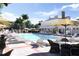Resort-style pool with lounge chairs, umbrellas, and patio seating at 110 W Railway Ave, Oakland, FL 34760