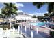 Pool and patio area with water features, lounge chairs, and umbrellas at 110 W Railway Ave, Oakland, FL 34760