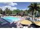 Relaxing pool area with lounge chairs, umbrellas, and water features at 110 W Railway Ave, Oakland, FL 34760