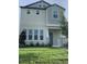 Two story home with light beige siding and a green lawn at 15102 Stuttgart Aly, Winter Garden, FL 34787
