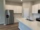 Modern kitchen featuring white cabinets and a large island at 15102 Stuttgart Aly, Winter Garden, FL 34787