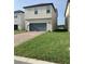 Two story house with a gray garage door at 15102 Stuttgart Aly, Winter Garden, FL 34787