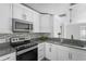 Modern kitchen with white cabinets and stainless steel appliances at 107 Hickory Tree Rd, Longwood, FL 32750