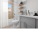 Stylish bathroom featuring wood-accent wall, modern fixtures, and open shelving at 2540 Sw 146Th Pl Rd, Ocala, FL 34473