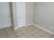 Simple bedroom with tile floors and neutral walls at 5107 Indialantic Dr, Orlando, FL 32808