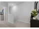 Upstairs hallway with neutral carpeting and a staircase at 693 Preston Cove Dr, Saint Cloud, FL 34771