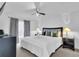 King-size bedroom with window, ceiling fan, and nightstands at 145 Cork Way, Davenport, FL 33897