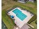 Relaxing community pool with lounge chairs and umbrellas at 145 Cork Way, Davenport, FL 33897