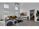 Spacious living room with L-shaped sofa and large TV at 145 Cork Way, Davenport, FL 33897