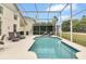 Screened pool and patio with lounge chairs at 145 Cork Way, Davenport, FL 33897