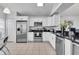 Modern kitchen with stainless steel appliances and granite countertops at 145 Cork Way, Davenport, FL 33897