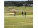Golfers walking on a green golf course at 145 Cork Way, Davenport, FL 33897