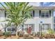 Light blue building exterior with gray shutters and landscaping at 4878 Conway Rd # 91, Orlando, FL 32812