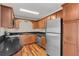 Modern kitchen with stainless steel appliances and wood cabinets at 4878 Conway Rd # 91, Orlando, FL 32812