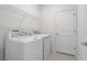 Bright laundry room, featuring washer, dryer, and ample shelving at 687 Hitch Loop, Saint Cloud, FL 34772