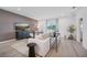 Living room with white sofa, dark accent wall, and hardwood floors at 33251 Country House Dr, Sorrento, FL 32776