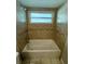 Bathroom with a shower/tub combo and tile surround at 307 Colonade Ct, Kissimmee, FL 34758