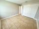 Spacious bedroom with tile floors and double door closet at 307 Colonade Ct, Kissimmee, FL 34758