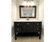 Updated bathroom with dark vanity and a large mirror at 307 Colonade Ct, Kissimmee, FL 34758
