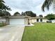 Front view of a single-story house with a stone accent and attached garage at 307 Colonade Ct, Kissimmee, FL 34758