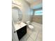 Bathroom features a tub, toilet and dark vanity at 307 Colonade Ct, Kissimmee, FL 34758