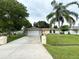 House exterior showcasing a two-car garage and landscaped front yard at 307 Colonade Ct, Kissimmee, FL 34758