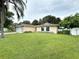 Landscaped yard with a single-story home featuring a large front lawn at 307 Colonade Ct, Kissimmee, FL 34758
