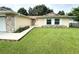 House exterior showcasing a stone facade, attached garage, and well-maintained lawn at 307 Colonade Ct, Kissimmee, FL 34758