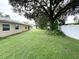 Large backyard with mature tree and privacy fence at 307 Colonade Ct, Kissimmee, FL 34758