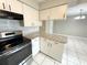 Updated kitchen with granite countertops and stainless steel appliances at 307 Colonade Ct, Kissimmee, FL 34758