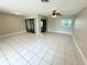 Bright and airy living room featuring tile floors and a ceiling fan at 307 Colonade Ct, Kissimmee, FL 34758