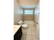 Clean bathroom with tub, toilet and dark vanity at 307 Colonade Ct, Kissimmee, FL 34758