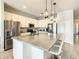 Modern kitchen with stainless steel appliances, white cabinets, and a large island at 547 Marcello Blvd, Kissimmee, FL 34746
