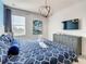 Spacious bedroom with large bed, dresser, and stylish decor at 547 Marcello Blvd, Kissimmee, FL 34746