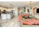 Open living room with gray sectional and coral pillows at 547 Marcello Blvd, Kissimmee, FL 34746