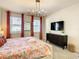 King size bedroom with TV and modern decor at 547 Marcello Blvd, Kissimmee, FL 34746