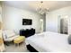 Main bedroom with king bed, yellow chair and walk-in closet at 547 Marcello Blvd, Kissimmee, FL 34746