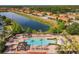 Resort-style community pool with plenty of lounge chairs at 547 Marcello Blvd, Kissimmee, FL 34746