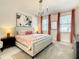 King-size bedroom with a modern chandelier and stylish decor at 547 Marcello Blvd, Kissimmee, FL 34746