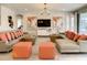 Spacious living room with sectional sofa, orange pillows, and large TV at 547 Marcello Blvd, Kissimmee, FL 34746