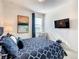Bedroom with TV, chair, and geometric wallpaper at 547 Marcello Blvd, Kissimmee, FL 34746