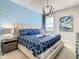 Spacious bedroom with a king-size bed, nightstands, and decorative wall art at 547 Marcello Blvd, Kissimmee, FL 34746