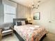 Guest bedroom with a comfortable chair and geometric rug at 547 Marcello Blvd, Kissimmee, FL 34746