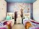 Two twin beds with Frozen themed bedding and wall mural at 547 Marcello Blvd, Kissimmee, FL 34746