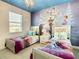 Two twin beds with Frozen themed bedding and wall mural at 547 Marcello Blvd, Kissimmee, FL 34746