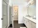Primary bathroom with a walk-in shower, double vanity, and dark floors at 547 Marcello Blvd, Kissimmee, FL 34746